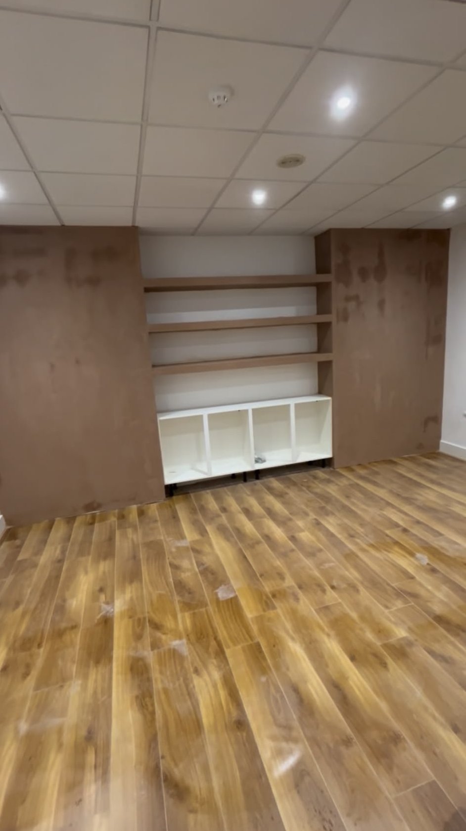 Dry lined and plastered office walls with built-in shelving recesses