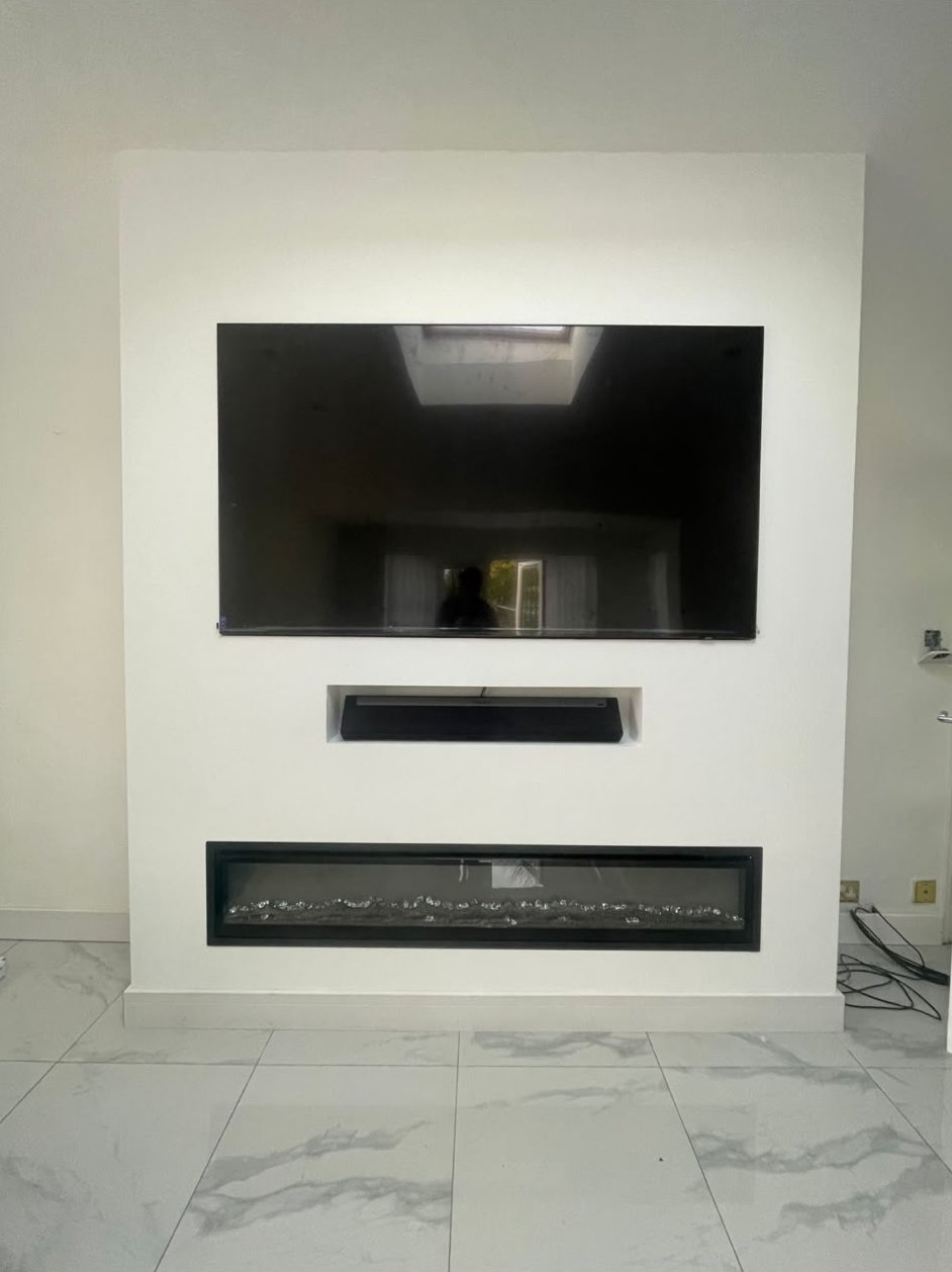 Plastered media wall with a recessed television, soundbar and inset electric fire in a Glasgow living room