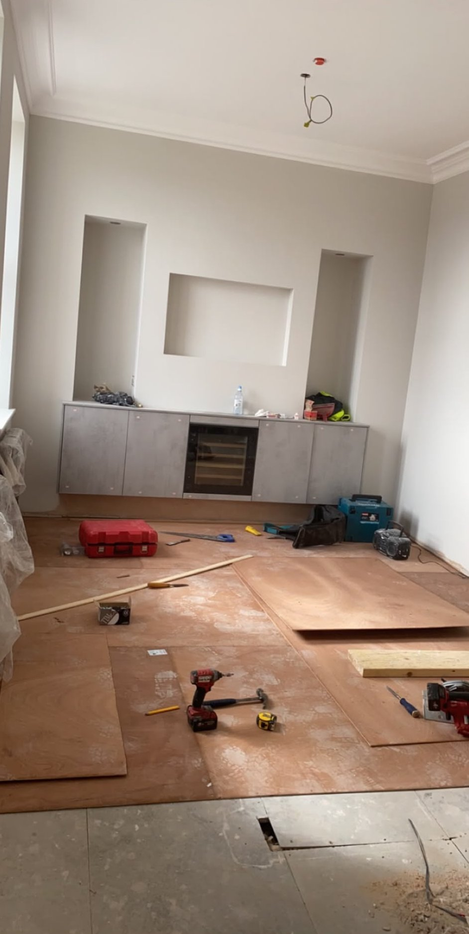 Living room ceiling overboarded and finished smooth to the cornice during a Glasgow refit