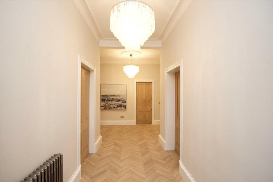 Restored decorative cornice running the length of a Glasgow tenement hallway ceiling