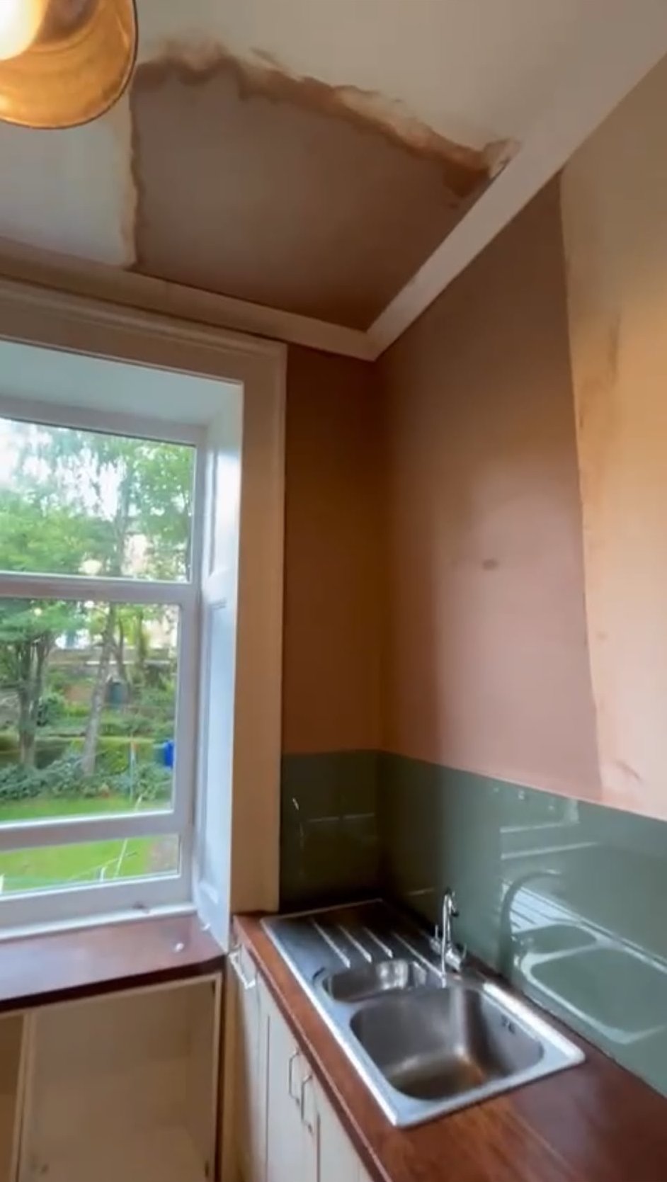 Water damaged kitchen ceiling and wall stripped back before re-plastering